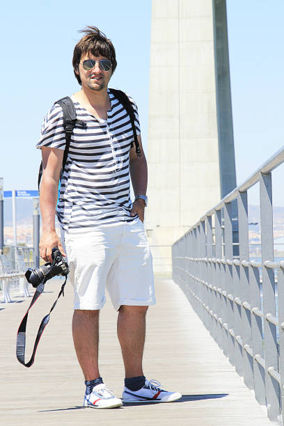 istock young man carrying a dslr camera 1760720592