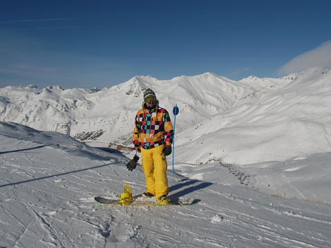 Man in snowy pirinees while practising snowboarding