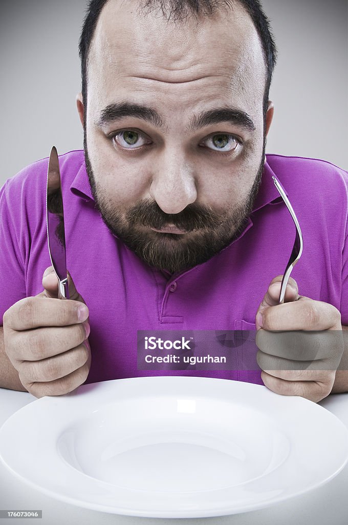 Dieting Overweight man very unhappy with his diet. studio shot. 30-34 Years Stock Photo