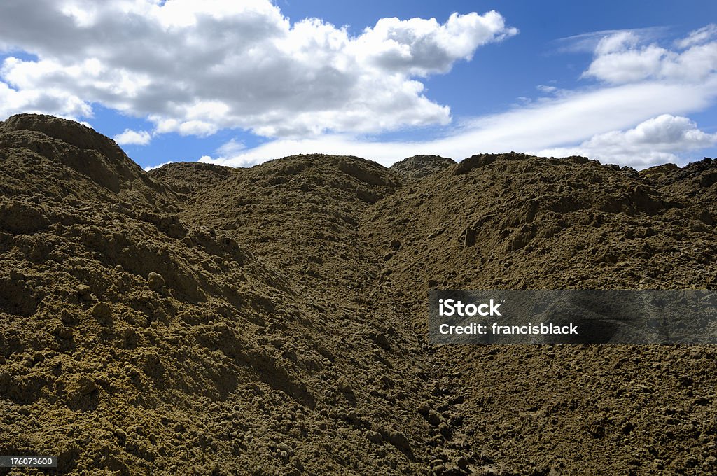 dirt mound View of a beautiful blue sky over a mound of dirt Agriculture Stock Photo