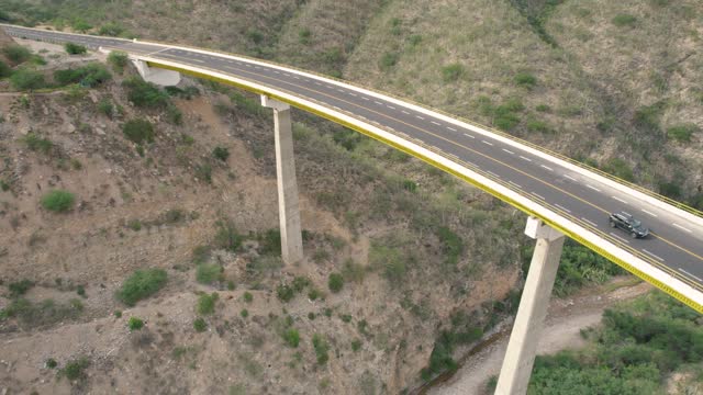 aerial view of large white truck crossing a big bridge somewhere in Mexico