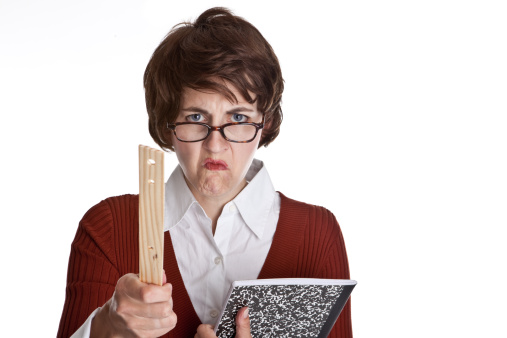 An angry teacher holding a composition book and pointing a ruler.