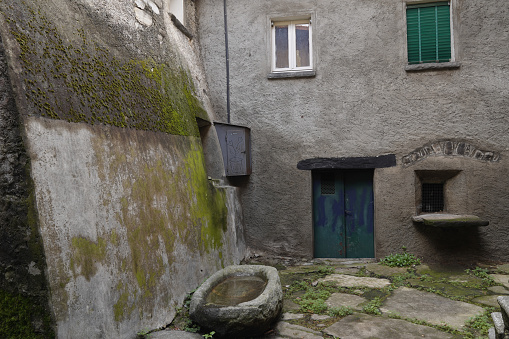 View of a glimpse of a street in the historic center of the anciente village of Palanzo. Lake Como, Italy