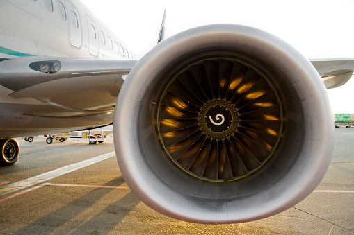 front view of a ge cfm56 jet engine.  Sun back liighting creating the internal glow.