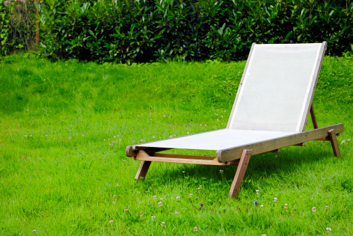 One sun chair in a garden.