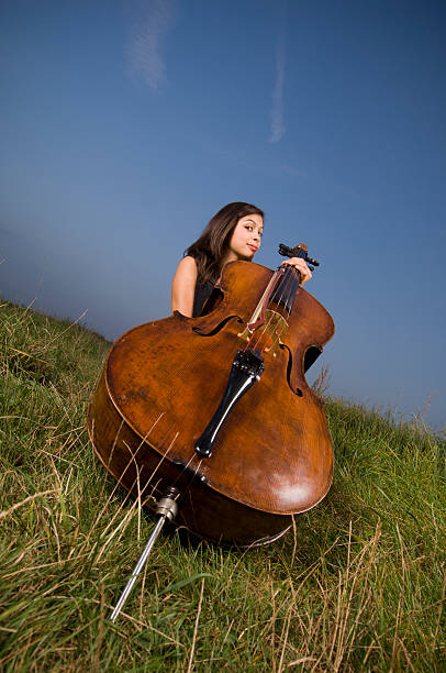 istock Young woman with cello 176075596