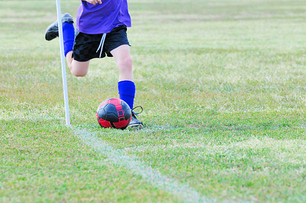istock Young Male Soccer Player Making a Corner Kick with Ball 176075976