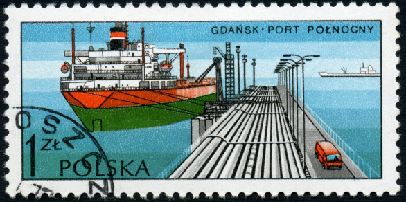 A one Zloty Polish postage stamp issued in 1976 depicting an oil tanker unloading at the Polish port of Gdansk.