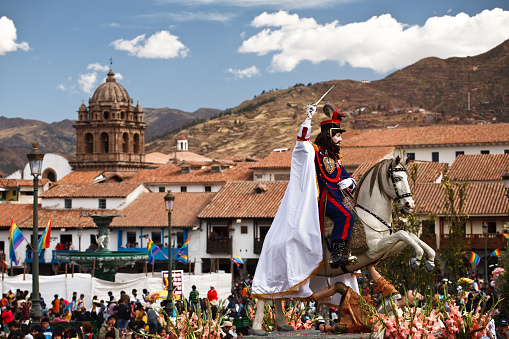 A statue of a man on horseback, one of the patron saints of a local Cuzco churches, tramples a statue of another man, likely the enemy of catholicism. Part of the Corpus Christi Catholic Religious Festival, Cuzco, Peru.