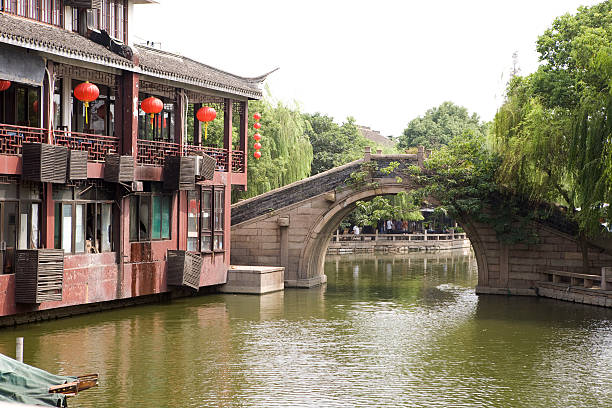 Xianjiang Bridge - Zhou Zhuang "Beautiful Chinese water town. Zhouzhuang is a popular tourist destination. It is one of the most famous water townships in China, noted for its profound cultural background, the well preserved ancient residential houses, the elegant watery views and the strong local colored traditions and customs. It has been called the ""Venice of the East""." water town zhouzhuang china stock pictures, royalty-free photos & images