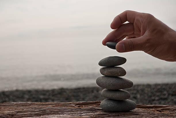 istock Clear foreground picture of a hand stacking rocks 176077245
