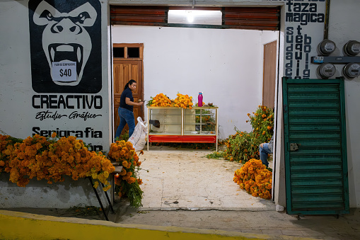 Huautla de Jimenez, Mexico- October 28, 2022: looking into a flower shop selling marigolds for Dia De Muertos.