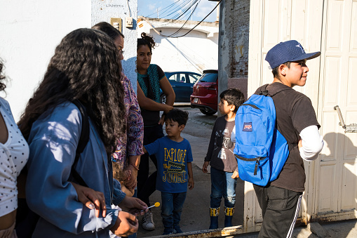 Oaxaca, Mexico- October 27, 2022: A family on the street during a Day of the Dead celebration