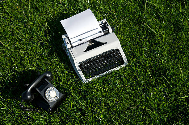 istock Old Fashioned Typewriter and Telephone in Grass 176078680
