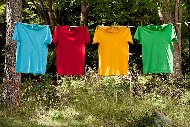istock Four colorful t-shirts having on a line outside 176078777