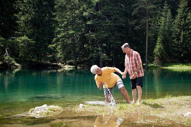istock elderly couple on mountain lake 176079256