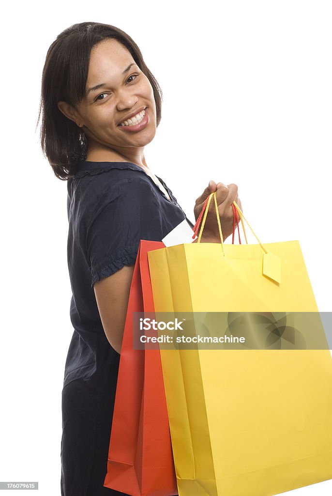 Happy Shopper Portrait of young woman carrying colorful shopping bags and smiling.  Isolated on white background. Red Stock Photo