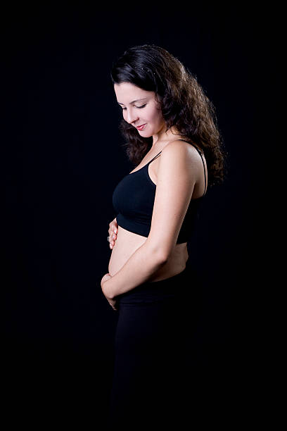 Pregnancy "4 months pregnant woman looking to her belly.For more of my similar images, please follow the banner link below:" 3 months pregnant belly stock pictures, royalty-free photos & images
