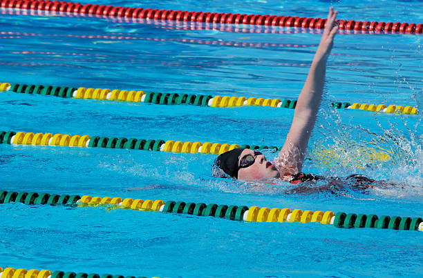 istock Young Girl Athlete Backstroke Swimmer Racing in Pool 176080131