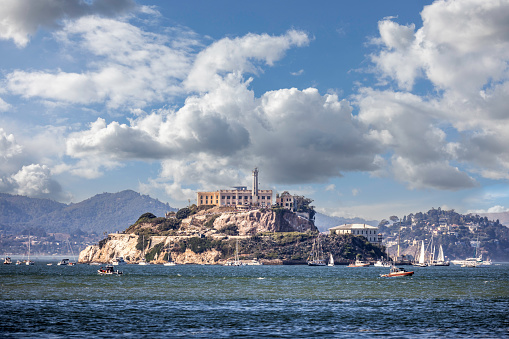 Alcatraz Island in San Francisco with  boats anchored in the bay on a gloriously sunny day.