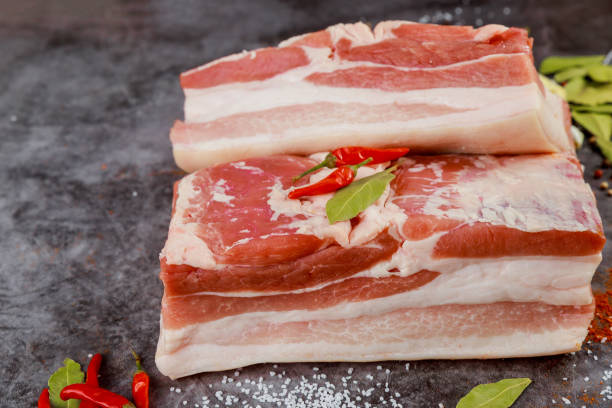 istock Pork belly meat pieces with hot pepper on grey background 1760811491