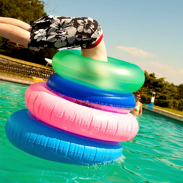 diving through hoops in pool on summer holiday