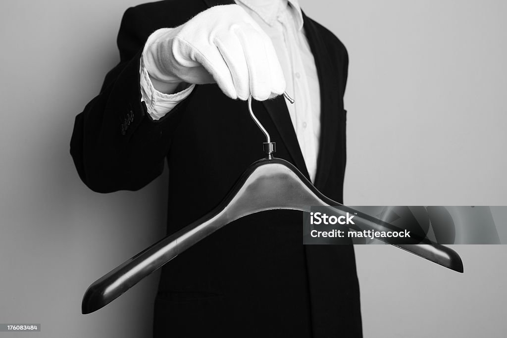 Assistance butler holding a coat hanger Concierge Stock Photo