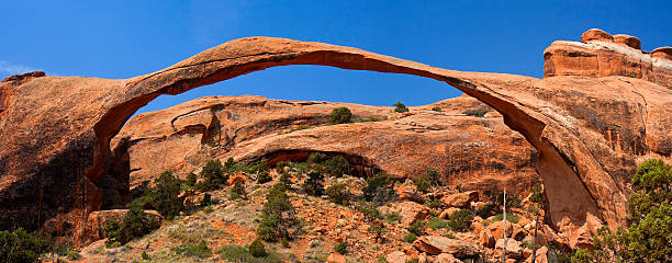 Landscape Arch, Arches NP, Utah, USA on a sunny day "The Landscape Arch in Arches National Park, Utah." landscape arch photos stock pictures, royalty-free photos & images
