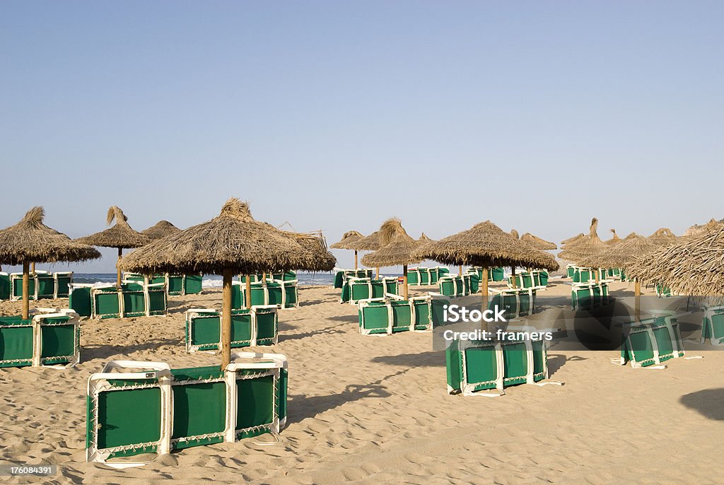 Sunchairs on the beach Folded sunchairs on the beach. Just waiting to be filled with happy sunbathers. Backgrounds Stock Photo