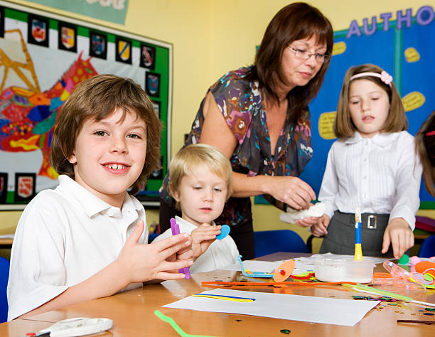 istock primary school: children enjoying art with their teacher 176085403