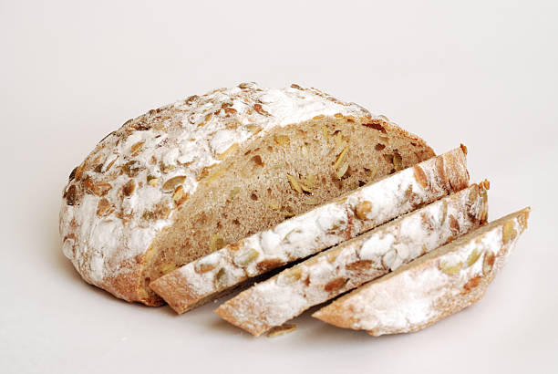 round loaf of bread with pepitas, sliced stock photo