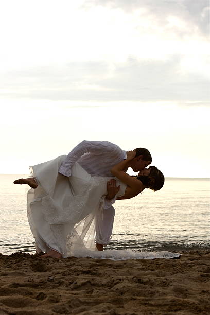 istock Bride and Groom Kissing on the Beach 176086325