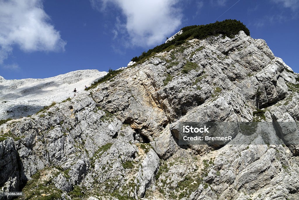 In the mountains Layers of rock in Julian Alps in Slovenia. Mount Velika Mojstrovka in the background. Cloud - Sky Stock Photo