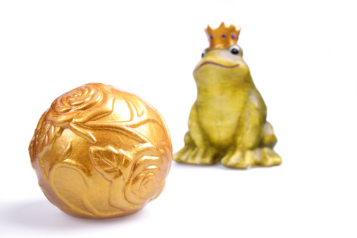 ceramic frog with crown and golden ball isolated on white - focus on foregroundrelated images: