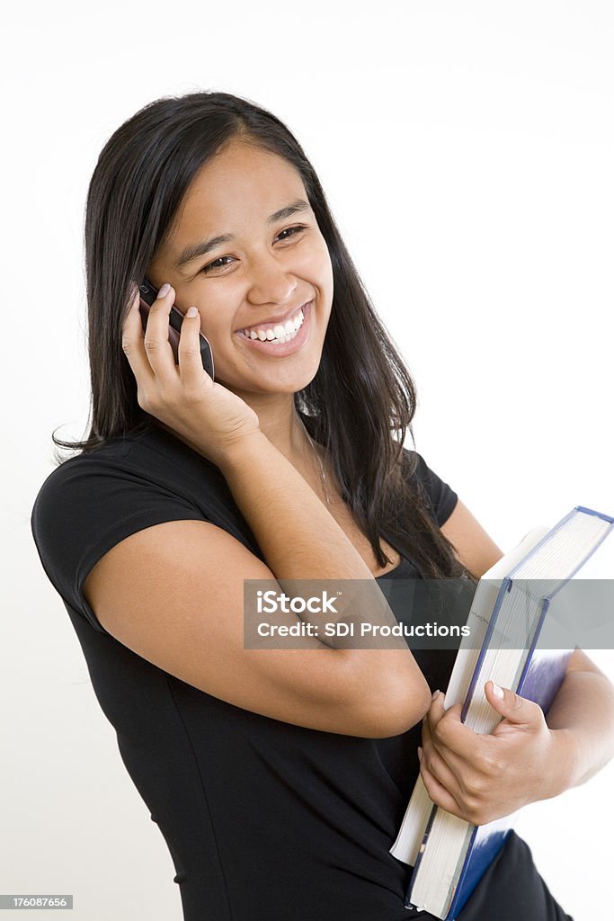 Happy College Girl Talking on Her Cell Phone Happy College Girl Talking on Her Cell Phone. Cut Out Stock Photo