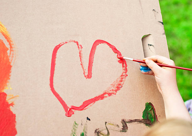 istock Child painting big red heart on cardboard 176088583