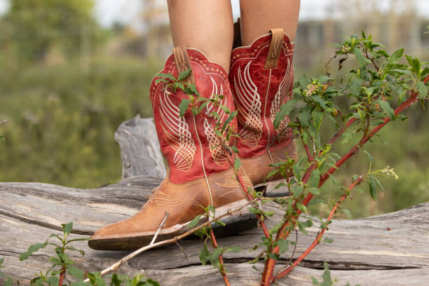 istock Woman in western boots standing on a log 1760890725