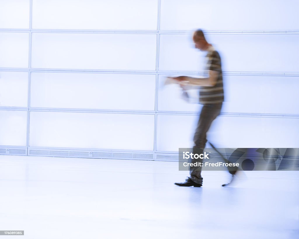 newspaper reader walking "man with newspaper walking, man in motion blur" Activity Stock Photo