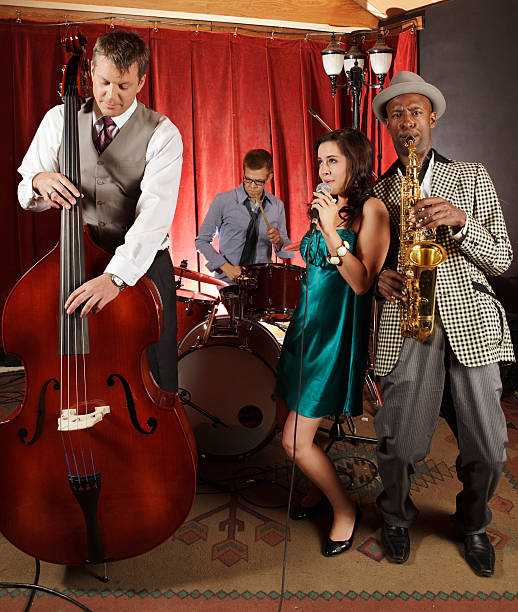 Jazz band with female singer playing at a night club stock photo