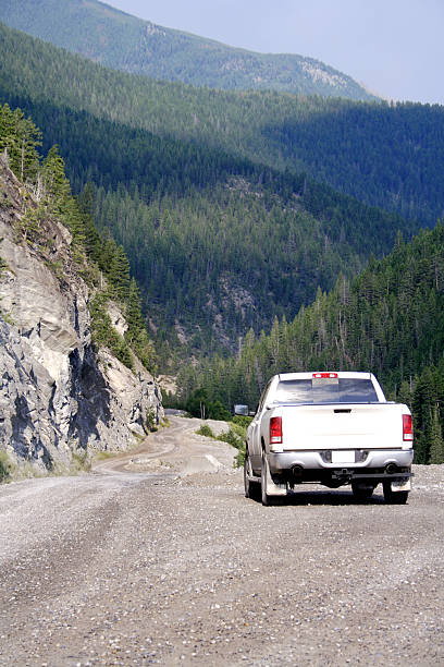 istock White truck driving along a mountainous road 176089729