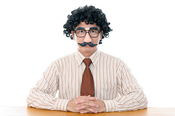 Portrait of a man with fake mustache on white.