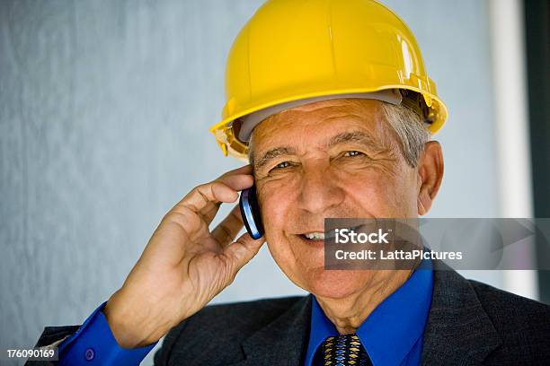 Close Up Of Senior Businessman Wearing Hardhat Stock Photo - Download Image Now - 60-69 Years, 70-79 Years, Active Seniors