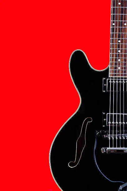 Black hollow body electric guitar closeup. Inspired by Gibson 335.
