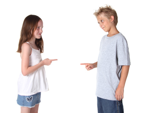 Two friends or siblings pointing at each other