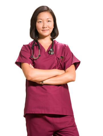 confident female doctor wearing scrubs isolated on white background.