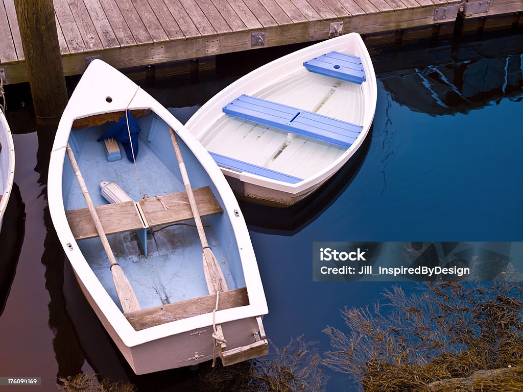 Dories tied at doc "Two dories tied to a dock in the marina at Kennebunkport, Maine harbor." Blue Stock Photo