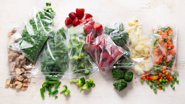 istock Frozen vegetable and berry fruit mix in plastic bags. 1760941876