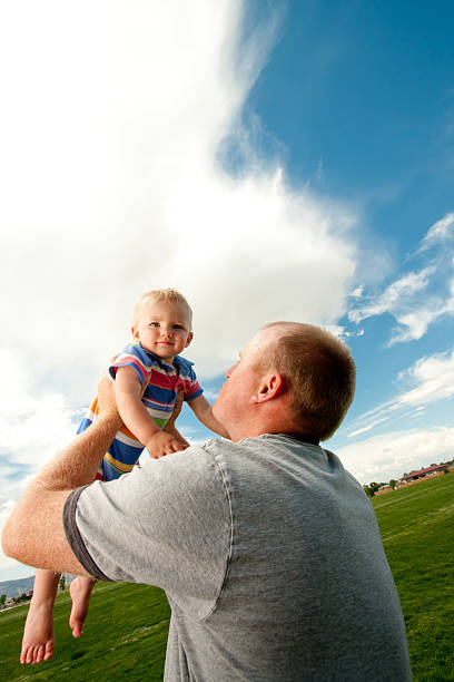 istock Father holding baby boy up 176094587