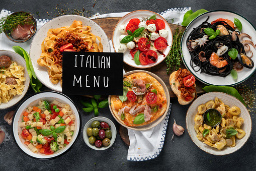 Italian food dishes on dark background. Traditional food concept. Top view.