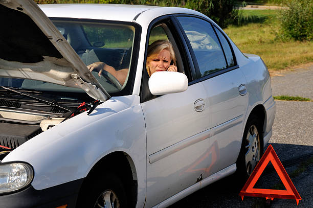 istock Woman on Cell Phone in Broken Down Car 176094928